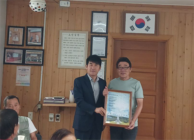 공석진 시인이 자작시 태극기 마을 발랑리를 아십니까를 장정옥 노인회장에게 전달하고 있다